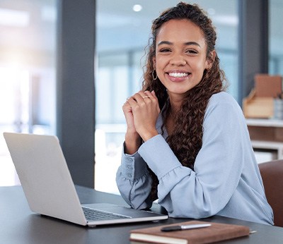 Woman smiling while working in office