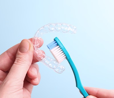 Patient cleaning clear aligner with toothbrush