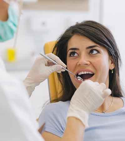 A dentist performing gum disease treatment on a patient