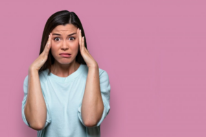 Woman holding her head, clearing stressing out